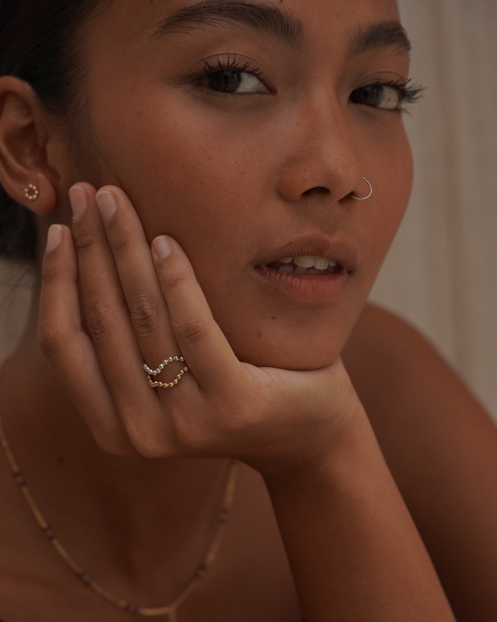 Model stacking Inari Jewellery's minimalist Ebb & Flow ring in Gold Filled and Sterling Silver
