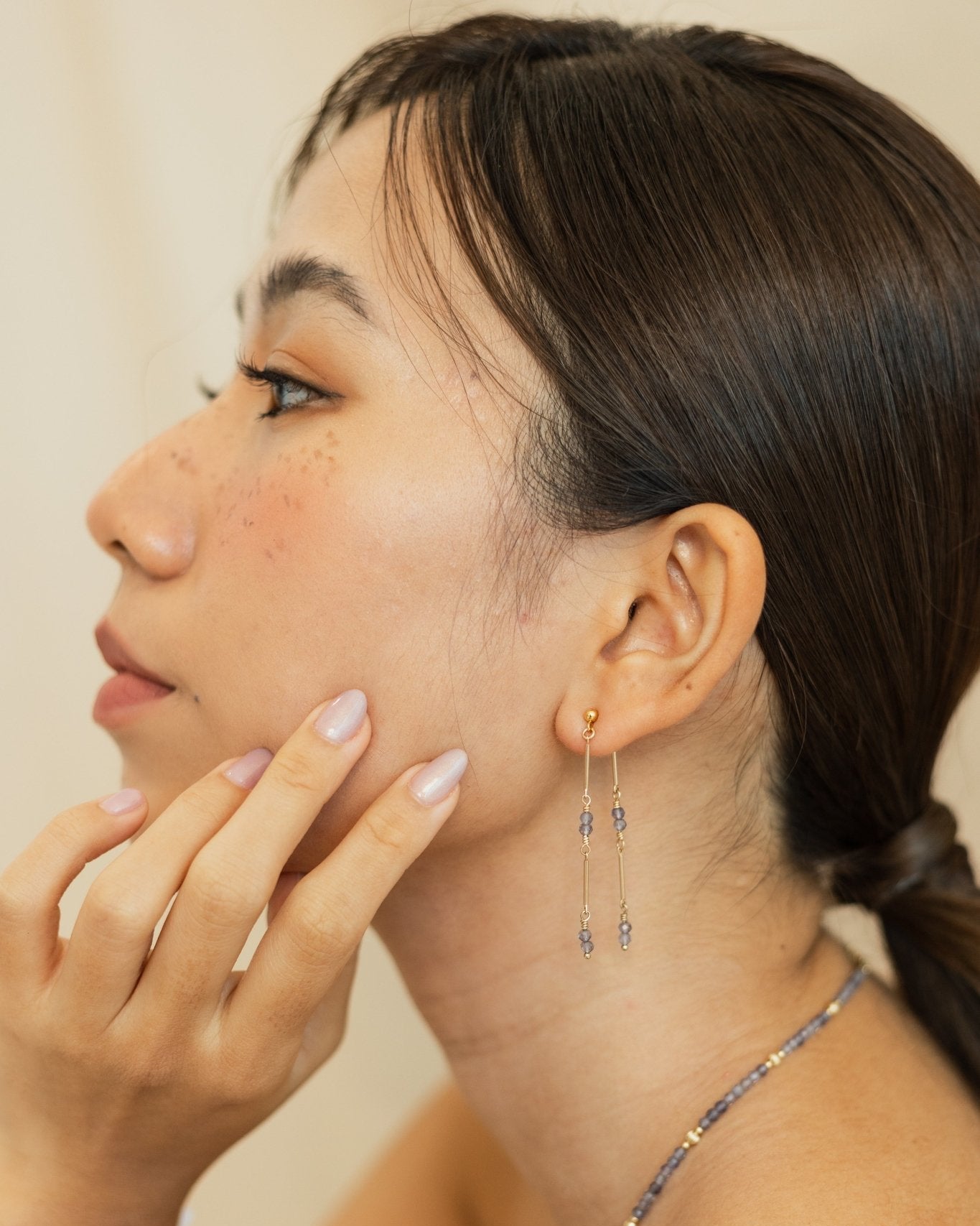 Elegant 14k gold-filled dangling earrings featuring deep Iolite gemstone