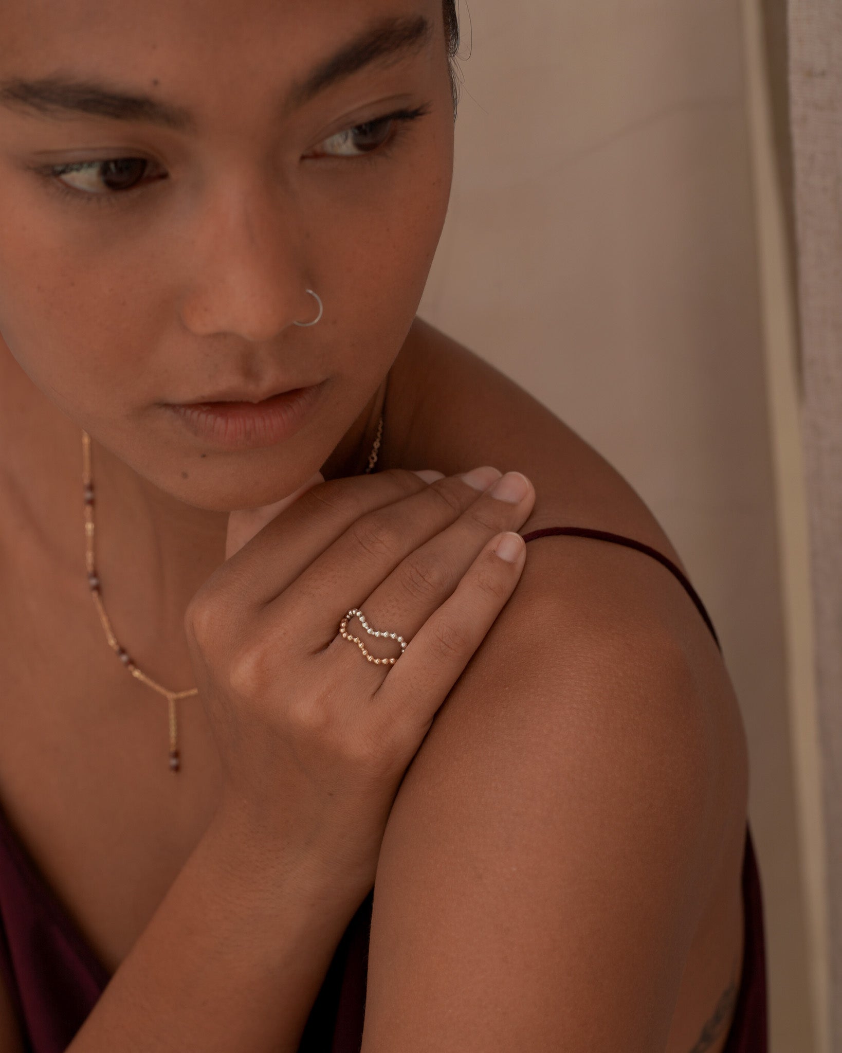Model stacking Inari Jewellery's minimalist Ebb & Flow ring in Gold Filled and Sterling Silver