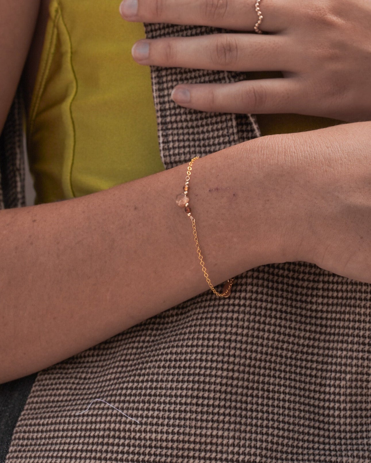 Model wearing golden hour gemstone bracelet with brown tourmaline and gold moonstone for a minimalist jewellery 