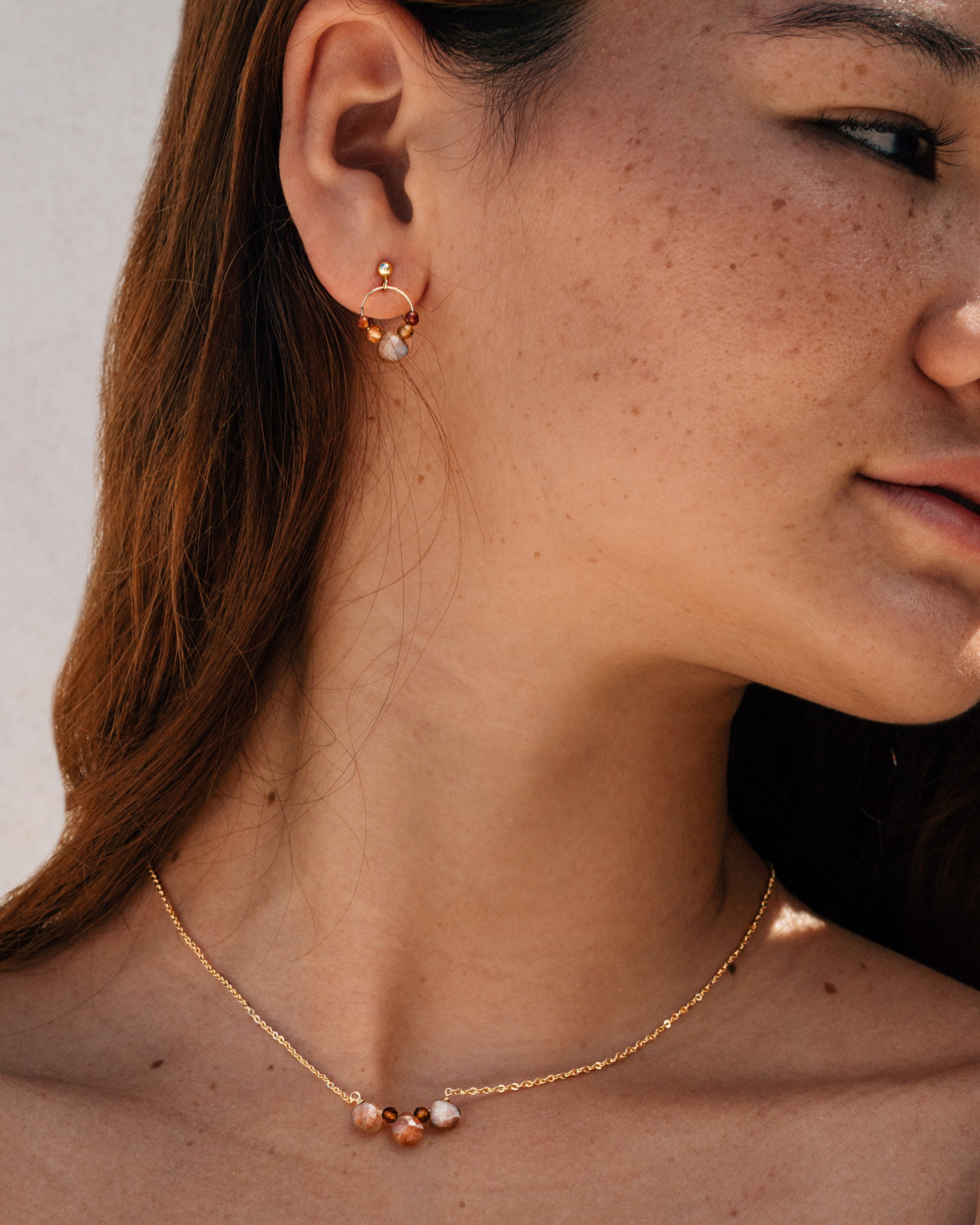 Model wearing minimalist brown gemstone jewellery