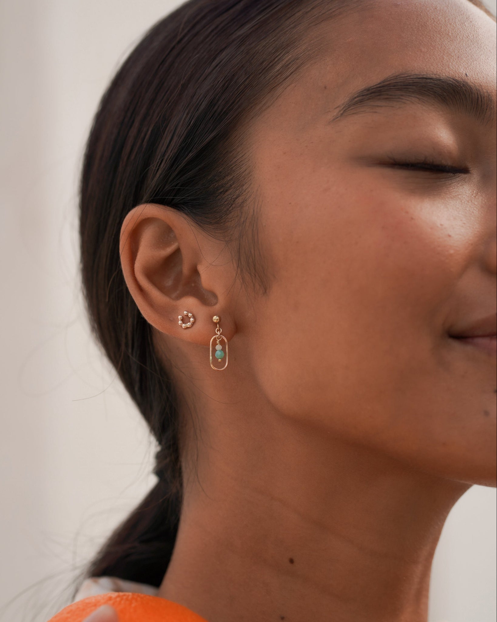 Model wearing our minimalist gemstone stud earrings for summer