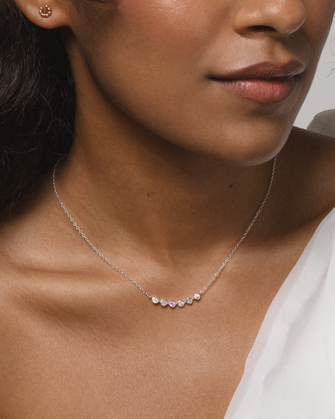 Modern minimalistic white gold necklace with zircon, labadorite and pink sapphire